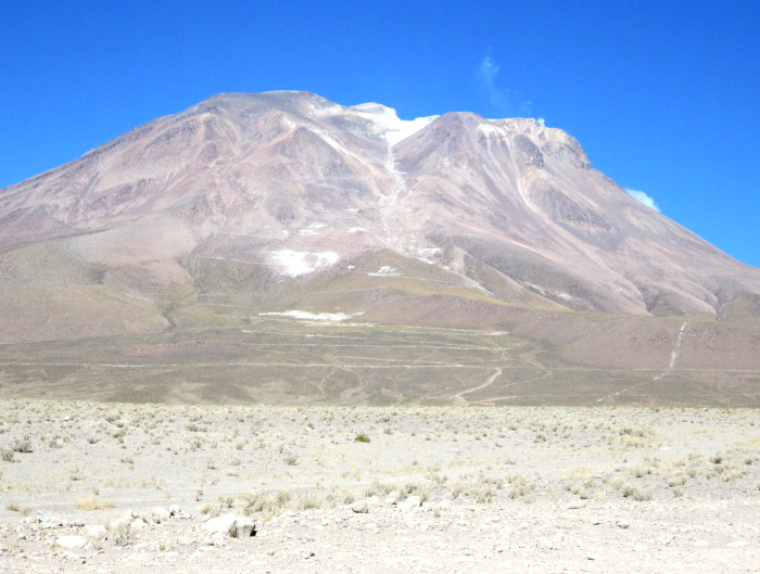 The high road can be seen zig-zagging uo the face in this photo of Ollague from the village. 